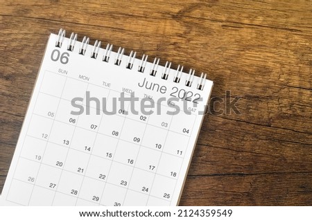 The June 2022 desk calendar on wooden background. Royalty-Free Stock Photo #2124359549