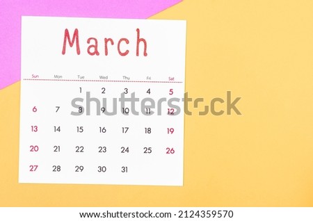 The March 2022 calendar on multicolored background.