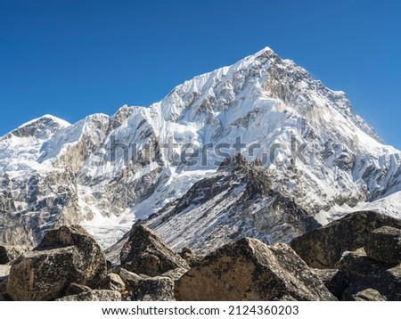 view to snow peak through stones in valley in Nepal