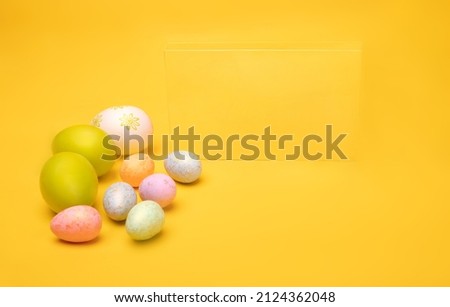 Hand painted easter eggs on a yellow background, horizontal view. Easter decorations, postcard, banner, photo with a copy space.