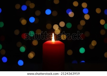 Burning candle with a beautiful bokeh in the background