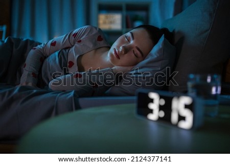 people, bedtime and rest concept - teenage girl sleeping at home at night Royalty-Free Stock Photo #2124377141