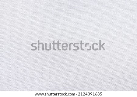 Flat white-colored glossy fabric texture background. This fabric is made of 100% polyester. Royalty-Free Stock Photo #2124391685