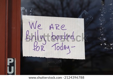Hand written sign on the door to a business. We are fully booked for today. Good news for any business owner. No appointments available. Royalty-Free Stock Photo #2124396788