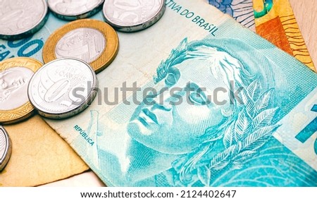 A one hundred Brazilian Real banknote in close-up photo with some coins on the side. Brazilian economy and finance.
 Royalty-Free Stock Photo #2124402647