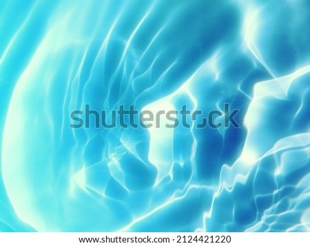 Reflection​ of surface​ blue​ water​ for​ background. Water​ splashed​ for​ background. Art​ texture​ for​ background. Water​ splashed​ in the​ deep​ sea. Blue​ water​ texture​ for background. Water.