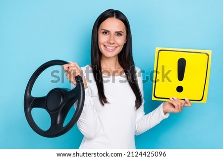 Photo of young woman hold paper symbol careful transport vehicle automobile isolated over blue color background