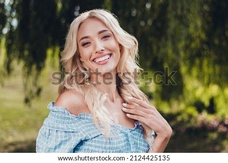 Portrait of attractive cheerful impressed wavy-haired girl enjoying good weather having fun outside outdoors