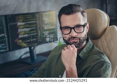 Portrait of experienced nerd guy thinking start-up website optimization strategy plan sit desk in modern loft workspace