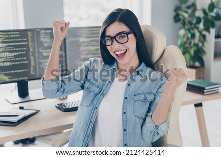 Photo of skilled lady editor sit desk fist up celebrate solving error optimization in workplace workstation
