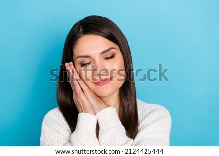 Photo of mature sleepy lady hand wear white pullover isolated on blue color background