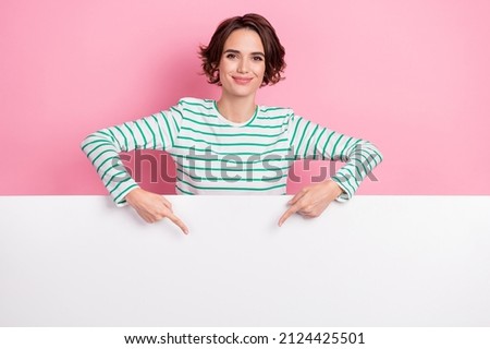 Portrait of attractive cheery girl demonstrating large big copy space poster advert ad offer isolated over pink pastel color background