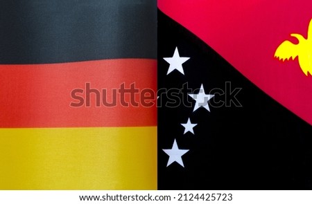 fragments of the national flags of Germany and Papua New Guinea close - up
