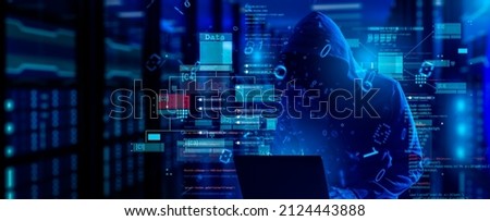 cybersecurity vulnerability Log4J and hacker,coding,malware concept.Hooded computer hacker in cybersecurity vulnerability Log4J on server room background.metaverse digital world technology. Royalty-Free Stock Photo #2124443888