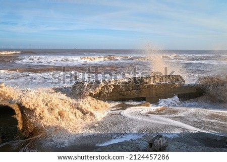Waves crashing over rocks on a beach
 Royalty-Free Stock Photo #2124457286