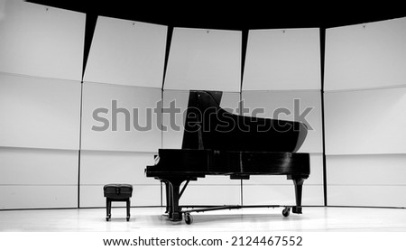 Black and white piano with bench on concert state for performance music musical drama
