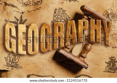 Embossed inscription "GEOGRAPHY" over an hourglass lying on the order of antique nautical chart depicting sailing ships.