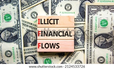 IFF illicit financial flows symbol. Concept words IFF illicit financial flows on wooden blocks on beautiful background from dollar bills. Business and IFF illicit financial flows concept. Copy space. Royalty-Free Stock Photo #2124533726
