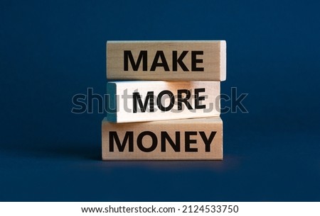 Make more money symbol. Concept words Make more money on blocks on beautiful grey table grey background. Business, make more money concept. Copy space.