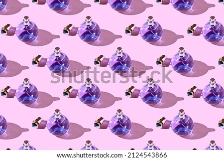 pattern with a bottle of perfume. Girl stuff. glass perfume bottle on a bright pink background with shadows and sunlight. Perfume bottles on a fashionable pink background. Beauty and fashion concept.  Royalty-Free Stock Photo #2124543866