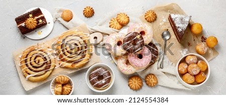 Desserts assortment on light background. Freshly made bakery and treats. Flat lay, top view, panorama Royalty-Free Stock Photo #2124554384