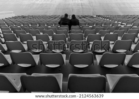 couple sitting in front of empty seats