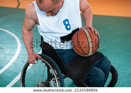 Close up photo of person with a disability playing basketball on the court. Selective focus 