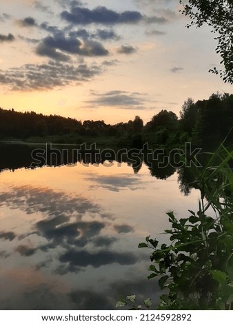 Beautiful evening sunset. Sunset over the lake. Sunset reflection in the water   Sunset in the forest. Sky.