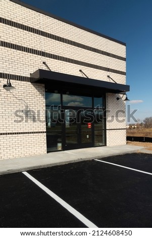 Horizontal shot of a new retail storefront under construction. Royalty-Free Stock Photo #2124608450