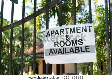 Apartment and rooms available, an advertisement on the gate for a house for rent. High quality photo