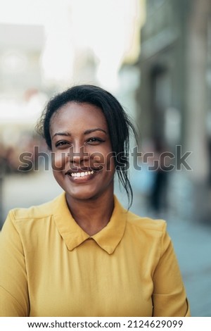 Beautiful young african american woman standing in the city street