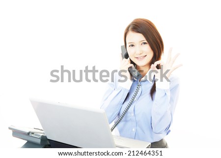 Happy young business woman making ok sign