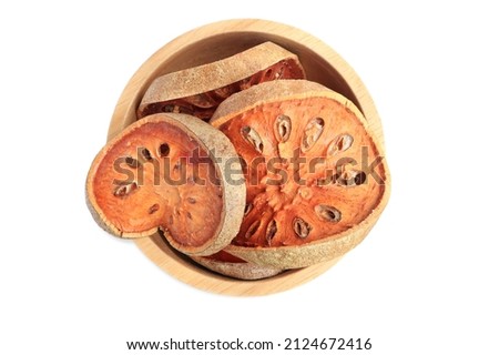 Slices of dry bael fruit,dry bael fruit tea (aegle marmelos) on the wooden bowl with clipping path.