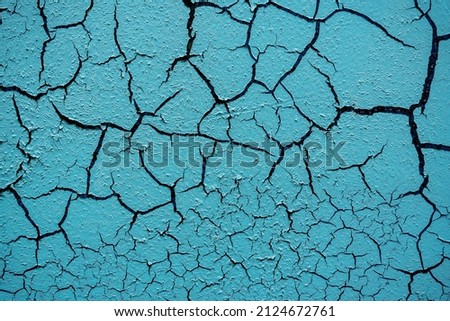 Cracked and damaged painted surface of a building or wall. Texture, aged paint background. High quality photo