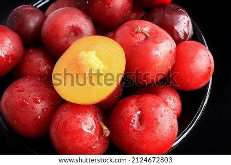 Ripe plums, fresh red plums on dark tone. background of beautiful home plums Royalty-Free Stock Photo #2124672803