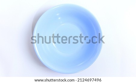 Empty blue bowl on white background with space for your meal. Food and beverage concept. Food Photography. High angle view. Flat lay. Top View.