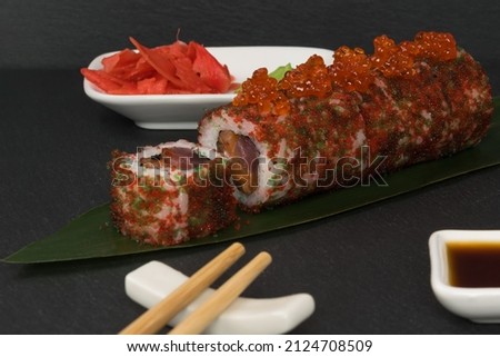 on a dark table accessories for sushi and rolls with tuna, background
