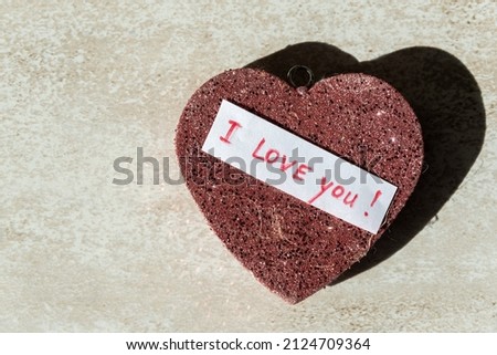 keychain in the shape of a red heart with sparkles and the inscription I love you close-up.