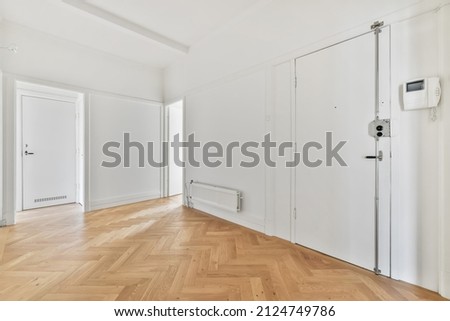 Empty room with a white wall and wood floor