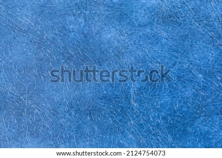 Fragment of the hard cover of book made with blue material remotely imitating leather close-up, texture, background 
