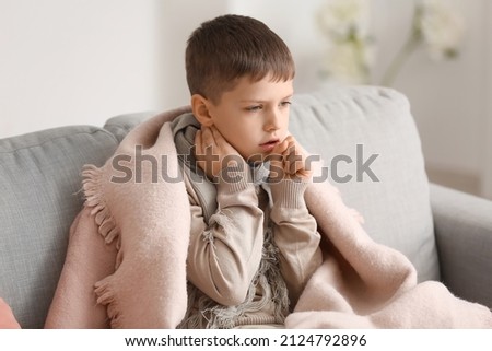 Ill little boy with sore throat at home Royalty-Free Stock Photo #2124792896