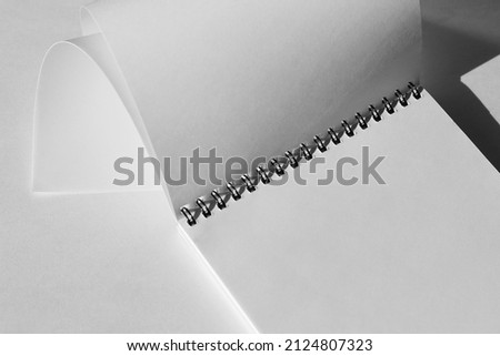 Blank Spiral Notebook Closeup on Office Desk Workplace. Minimal Graphic Mockup Template for Designer.