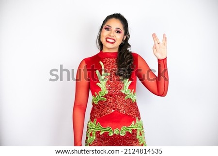 Young beautiful woman wearing carnival costume over isolated white background doing hand symbol