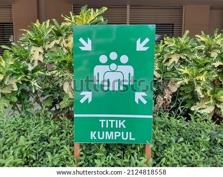Assembly point or titik kumpul. A sign board in Bahasa or Indonesia language.