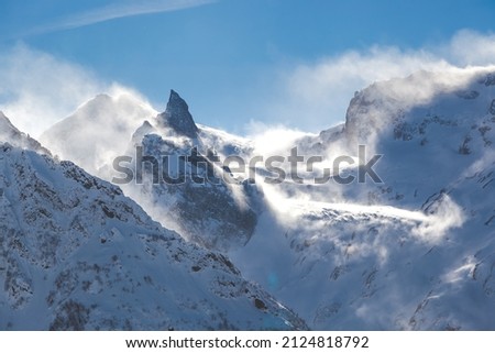 view of high mountains in the snow, strong wind in the mountains.