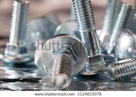 the nut-to-bolt fastening system is made of steel, metal steel bolts for nuts for installation work Royalty-Free Stock Photo #2124833078