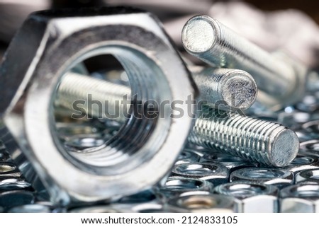 metal steel nuts for installation work , the nut-to-bolt fastening system is made of steel Royalty-Free Stock Photo #2124833105
