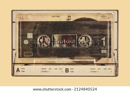 Retro styled image of a vintage audio compact cassette in a plastic storage box Royalty-Free Stock Photo #2124840524