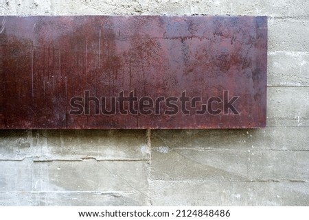 Rusty Metal Plate on Raw Concrete Wall Texture Background.