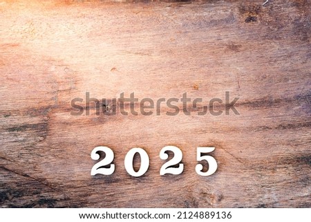 Wood text 2025 on sheet wooden background. Empty space. Happy New Year concept.